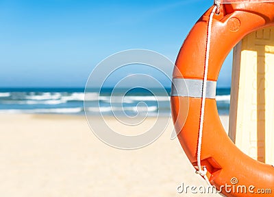 Seascape with lifebuoy, blue sky and sandy beach. Stock Photo