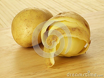 Half peeled potatoes Stock Photo