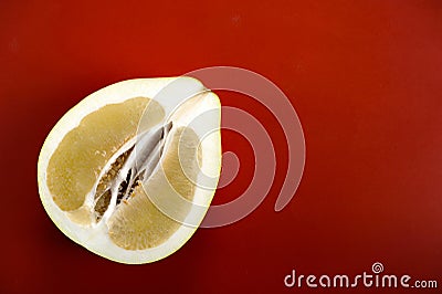 Half a pomelo on a red background Stock Photo