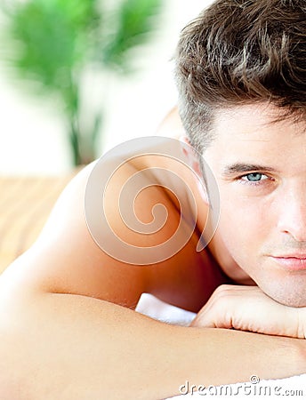 Half portrait of a handsome man lying on a massage Stock Photo