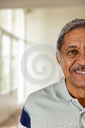 Half portrait of happy senior biracial man at home with copy space Stock Photo