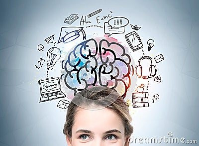 Half portrait of inspired attractive young student woman. Colorful business education and e-learning sketch drawn on wall behind. Stock Photo