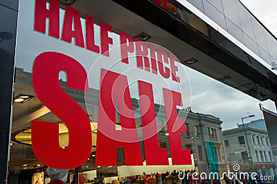 Half price sale sign in a shop window. Stock Photo