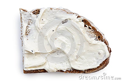 Half slice of rye bread with cream cheese spread isolated on white from above. Stock Photo