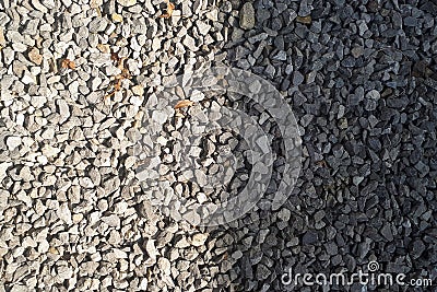 Half stone is light, half dark.sun and shadow.stone background, dark gravel pebbles stone Stock Photo