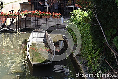 Half sunken wooden boat in romantic canal ,little Venice, in Colmar, France. Stock Photo