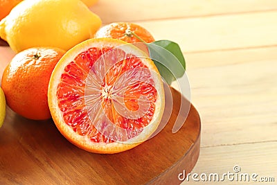 Half of tasty Sicilian orange with citrus fruits on board Stock Photo
