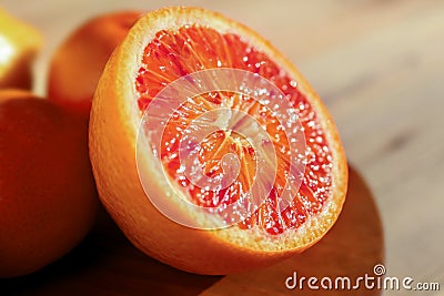 Half of tasty Sicilian orange on table, closeup Stock Photo