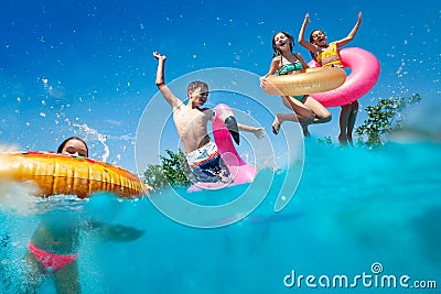 Half underwater split image of kids dive to pool Stock Photo