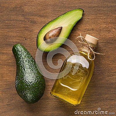 Half and whole avocado and oil in bottle Stock Photo