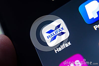Halifax bank app seen on the edge of on the smartphone screen along with other banking apps Editorial Stock Photo