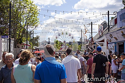 Halifax Fair Grounds Amusement Park is a Tourist Attraction Ferris wheel and loads of Tourism People busy crowded summer Location Editorial Stock Photo