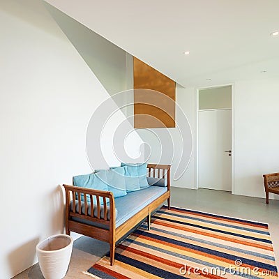 Hall with divan and striped rug Stock Photo