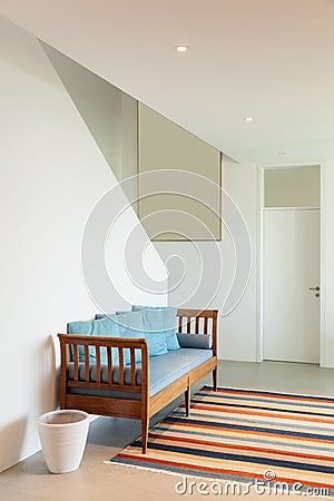 Hall with divan and striped rug Stock Photo