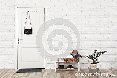 Hall interior with brick wall and white door Stock Photo