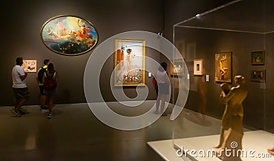 Hall of National Art Museum of Catalonia with visitors contemplating paintings Editorial Stock Photo