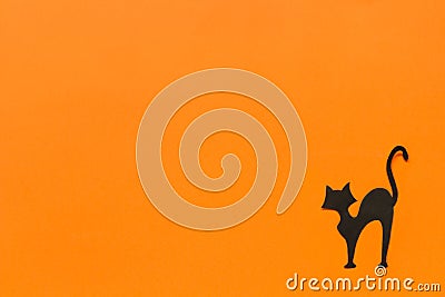 Halloween background. Black paper cat on orange background Stock Photo