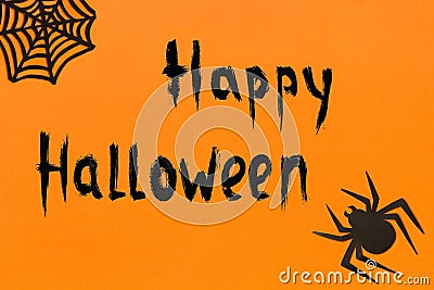 Halloween background. Text Happy Halloween Black paper spider and spiderweb on orange background Stock Photo