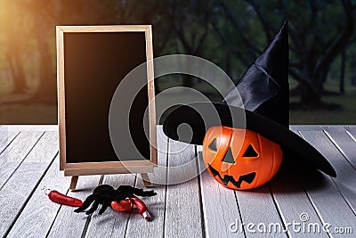 Halloween background. Spooky pumpkin, chalkboard on wooden floor Stock Photo