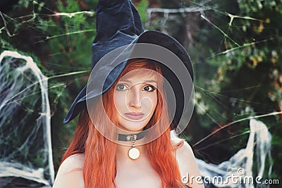 Halloween Beautiful young Witch girl in witches hat Stock Photo