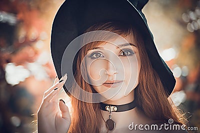 Halloween Beautiful young Witch girl in witches hat Stock Photo
