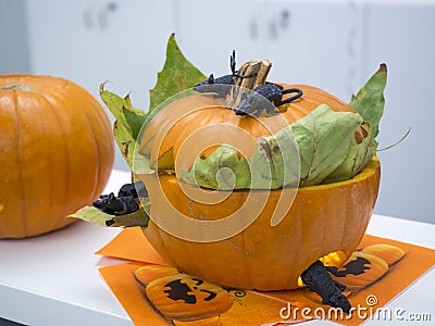 Halloween big orange pumpkin decorated with scary face. Jack O` Lantern on white table background Stock Photo