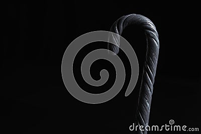 Halloween black candy cane on black background Stock Photo