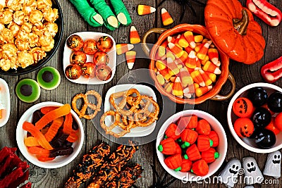 Halloween candy buffet table scene over a rustic wood background Stock Photo
