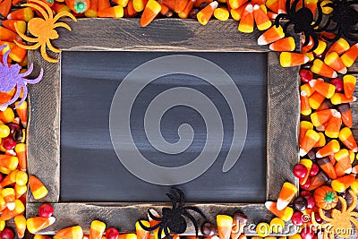 Halloween candy frame around chalk board Stock Photo