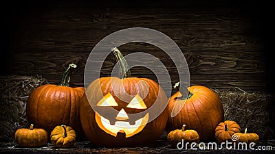 Halloween Carved Pumpkin. Jack O Lantern smile face. Illuminating with burning candle inside scary Jack o Lantern. Happy Halloween Stock Photo