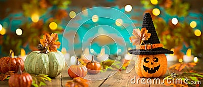 Halloween celebration concept with jack o lantern pumpkin and autumn leaves. Holiday banner Stock Photo