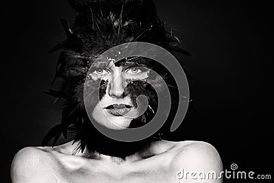 Halloween character, black and white portrait. Bird woman makeup on dark Stock Photo