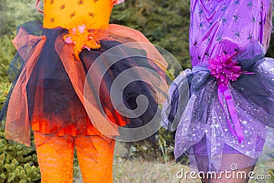 Halloween closeup witch orange and purple dress with spiders. Stock Photo