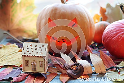 Halloween composition of jack o` lantern, pumpkins, illumination, mystical decor Stock Photo