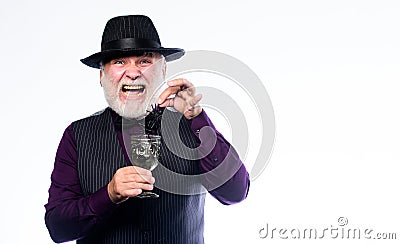 Halloween concept. Disgusting Halloween drink. Elegant bartender wear hat and vest prepare drink. Horror themed Stock Photo