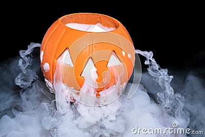 Halloween concept with pumpkin lantern & smoky the effect of dry ice Stock Photo