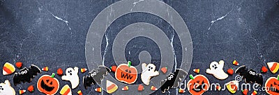 Halloween cookie bottom border on a dark stone banner background Stock Photo