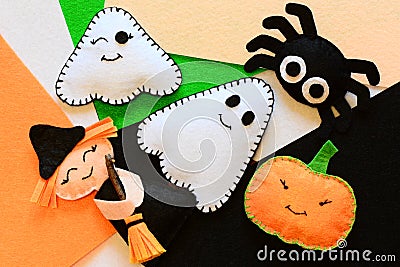 Halloween cute felt ornament decor. Small witch with broom, pumpkin head, two ghosts, spider. Halloween toys crafts Stock Photo