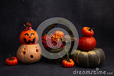 halloween decor, pumpkins, candy bowl, lantern, basket with red berries lie on a black background Stock Photo