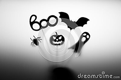 Halloween Decoration. Shadows pumpkin, bat, ghost, spider, and Boo word on the gray background. Stock Photo