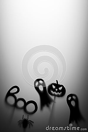 Halloween Decoration. Terrifying Shadow Puppets. Shadows pumpkin, ghost, spider, and Boo word on the gray background. Stock Photo