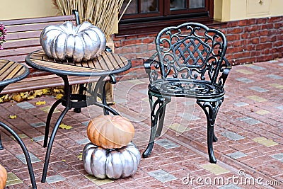 Halloween element -pumpkins and flowers with witch`s broom on the table and floor Stock Photo