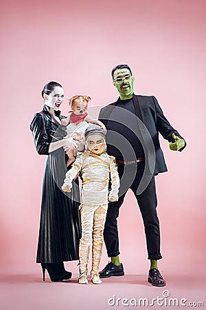 Halloween Family. Happy Father, Mother and Children Girls in Halloween Costume and Makeup Stock Photo