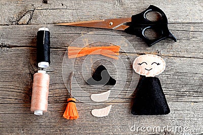 Halloween felt witch details, scissors, thread, needles on wooden background. Handmade crafts. Step. Top view Stock Photo