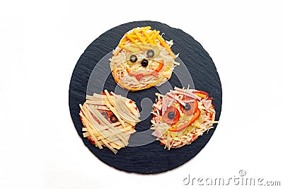 Halloween food idea - homemade pizza, Mini pizzas decorated with spiders and mummies for a Halloween. Stock Photo