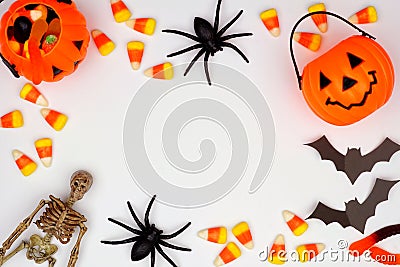 Halloween frame of scattered candy and decor over white Stock Photo