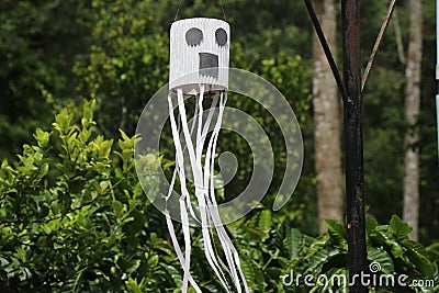 Halloween ghost made at home as a decoration item for halloween is hung on the outdoors for party Stock Photo