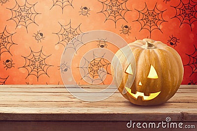 Halloween holiday background with pumpkin on wooden table Stock Photo