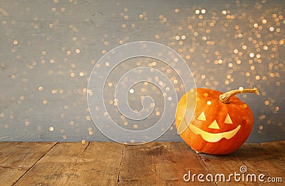 Halloween holiday concept. Cute pumpkin on wooden table Stock Photo