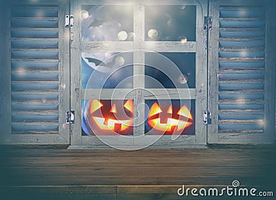 Halloween holiday concept. Empty rustic table in front of haunted night sky background and old window. Ready for product display m Stock Photo